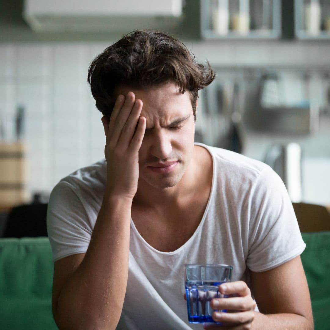 Man suffering from a hangover induced headache